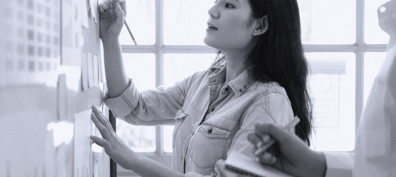 woman writing on board